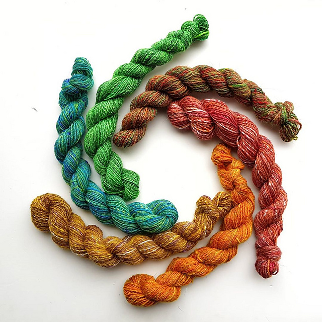 Rainbow skeins. Six mini skeins of yarn, arranged in a circle.