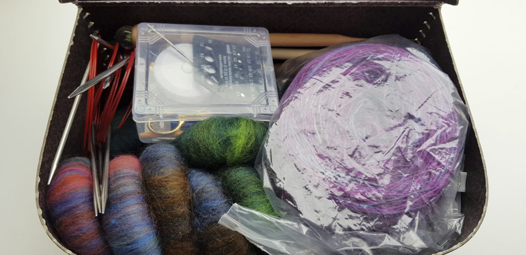 A small suitcase filled with fibre craft supplies