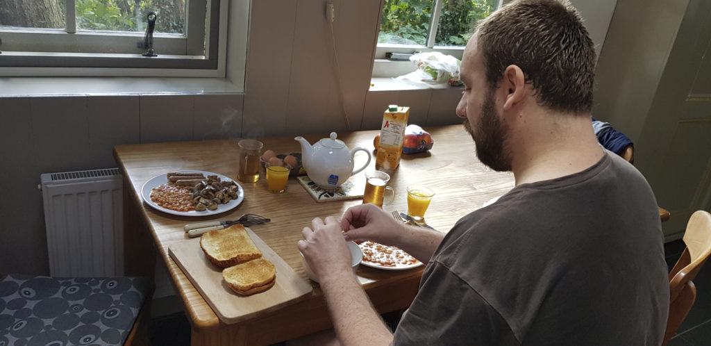 A kitchen table with English breakfast for two