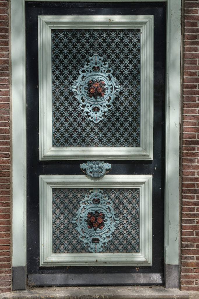 An ornamented front door with iron work