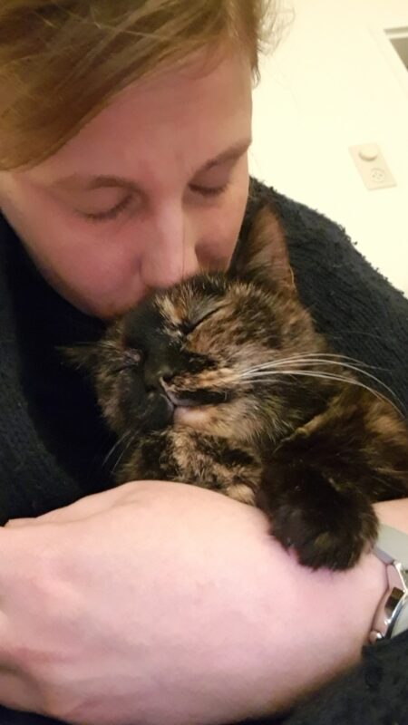 Freya and me cuddling. She looks as if she likes it, but is not purring.